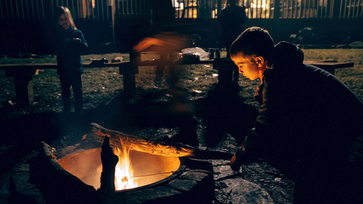 Two children roasting marshmallows at a fire (photo credit - Michael Aleo)